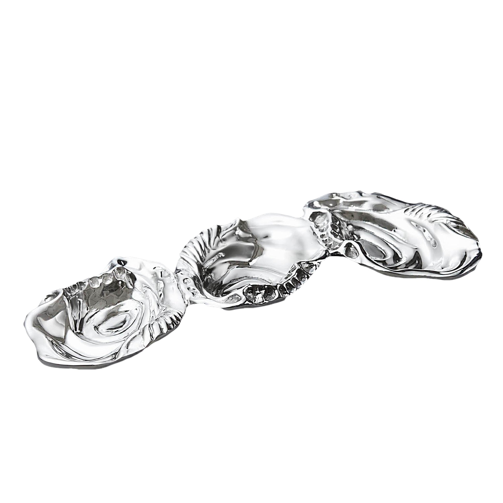 The Beatriz Ball Ocean Oyster Triple Dip features three connected silver dishes with shell-like, wavy edges, crafted from sand-cast metal and shown on a white background.