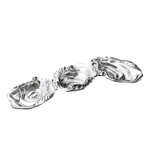 The Beatriz Ball Ocean Oyster Triple Dip features three connected silver dishes with shell-like, wavy edges, crafted from sand-cast metal and shown on a white background.