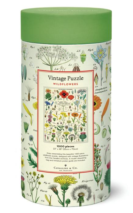 The Cavallini Papers and Co Wildflowers 1,000 Piece Puzzle comes in a cylindrical box with botanical designs, a green lid, and includes a handsewn muslin bag for storing pieces.