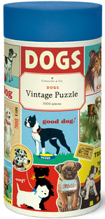 The Cavallini Papers and Co Dogs 1,000 Piece Puzzle comes in a cylindrical container, featuring dog breed illustrations and vintage graphics from the Cavallini archives.