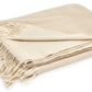 Displayed against a white background, the Matouk Paley Cashmere Throw by Matouk is an oversized beige throw adorned with fringe edges.