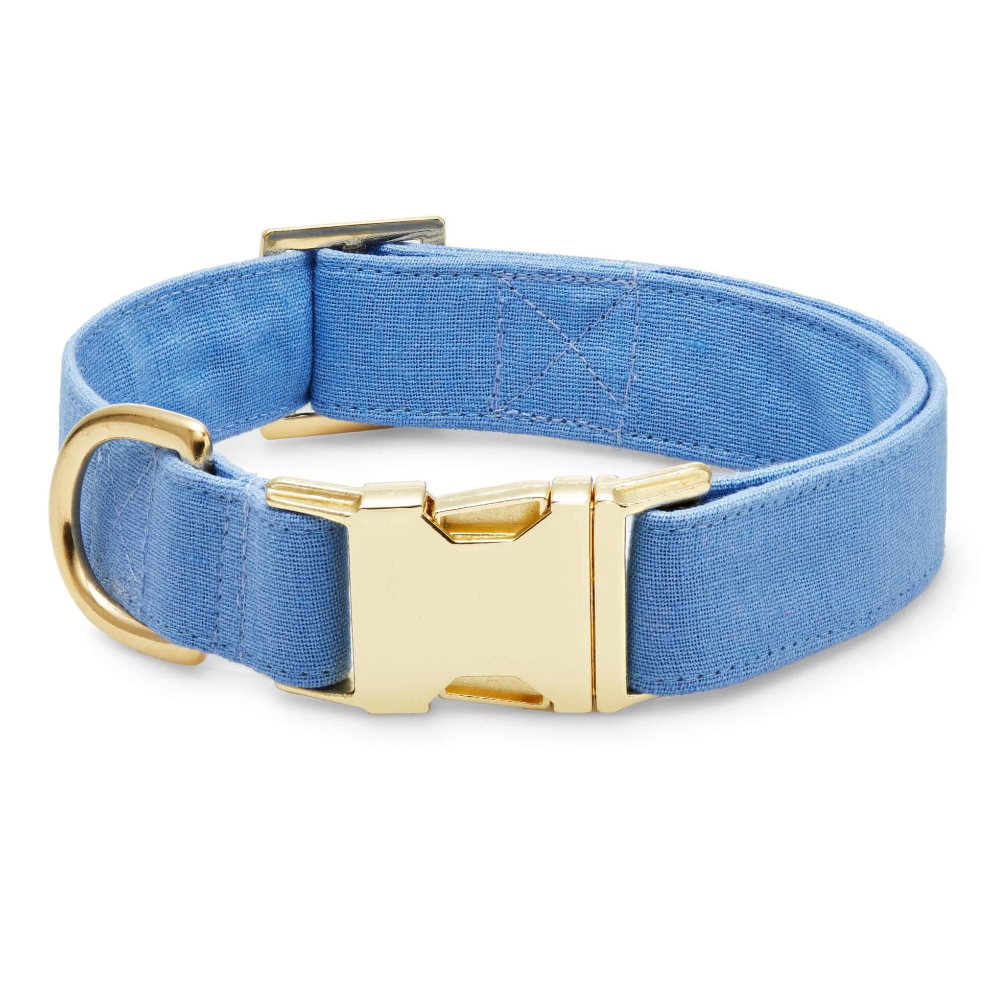 The Foggy Dog Fabric Dog Collar, shown on a white background, features blue fabric with a chic design and gold-tone hardware, including a metal buckle and D-ring.