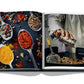 Open cookbook displaying vibrant photographs of various spices and a chef seasoning food in a kitchen near the Red Sea: The Saudi Coast by Assouline.