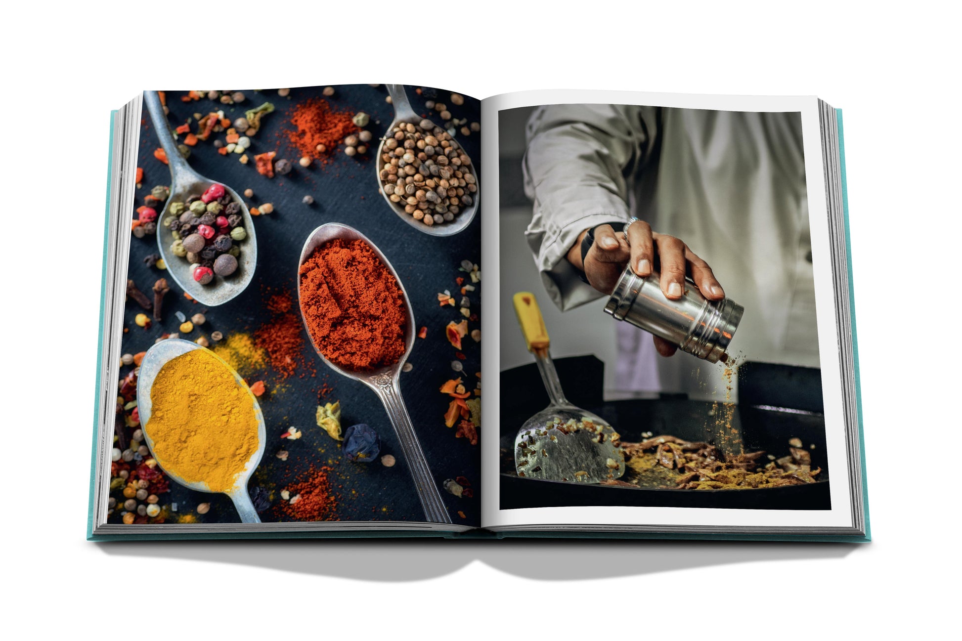 Open cookbook displaying vibrant photographs of various spices and a chef seasoning food in a kitchen near the Red Sea: The Saudi Coast by Assouline.