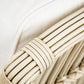 Close-up of a PALECEK President's State Chair armrest, featuring a white cushion and visible woven rattan accents that showcase the natural texture and color.