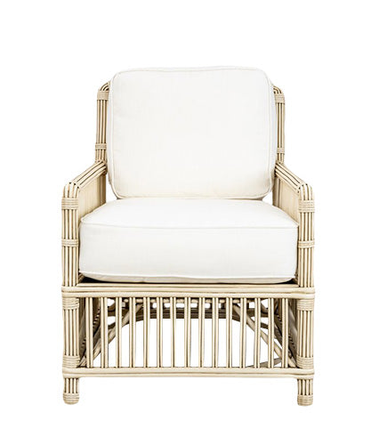 The President's State Chair by PALECEK is a vintage white chair featuring rattan accents and white cushions, highlighted by vertical and horizontal weaving on the arms and base.