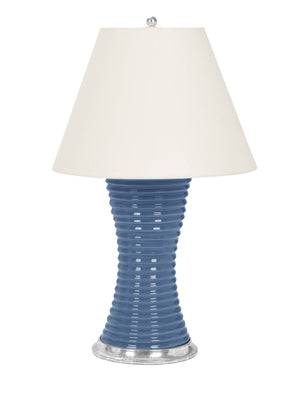 A Ribbed Hourglass Lamp by Christopher Spitzmiller, a blue ceramic table lamp with a white shade.