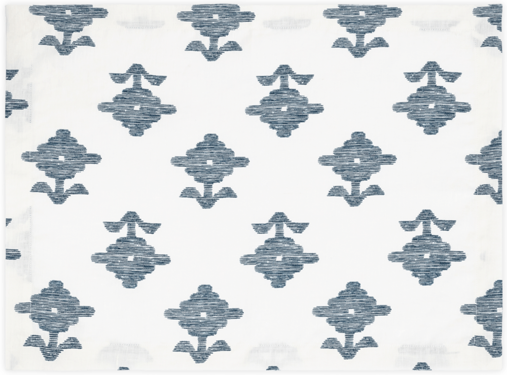 The Rubia Navy Placemats by Matouk feature white linen with a repeating geometric pattern of textured dark blue diamond shapes, evenly spaced for a refined, elegant look. Set of 4.