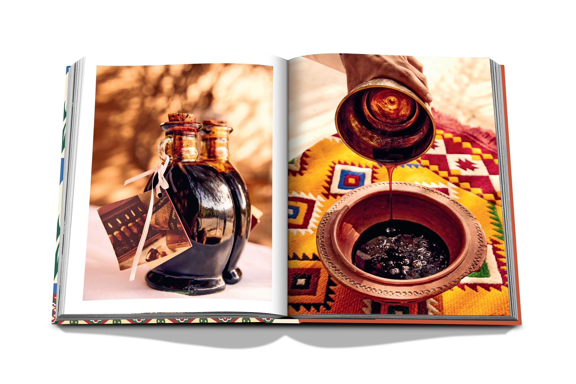 An open book displaying a photograph of a person pouring a dark liquid from Saudi Dates into a bowl on a colorful textile. (Assouline)