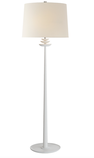 The Beaumont Floor Lamp by Visual Comfort is a white floor lamp with a slender plaster base and a round fabric shade, featuring E26 keyless for versatile bulb compatibility.