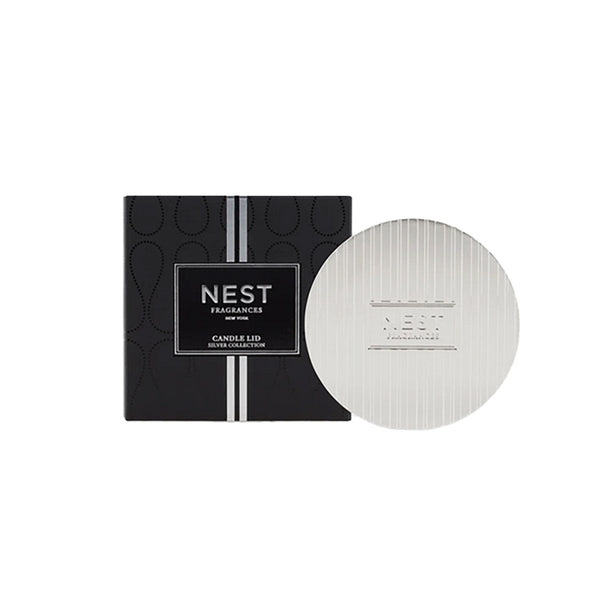 A NEST Silver Classic Candle Lid with a Nest logo on it.