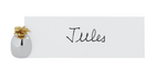 The Ercuis Pineapple Placecard Holder displays a white card with the name "Jules," its silver base and gold pineapple detail adding a charming touch to your table accessories.