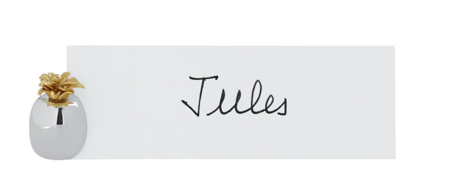 The Ercuis Pineapple Placecard Holder displays a white card with the name "Jules," its silver base and gold pineapple detail adding a charming touch to your table accessories.