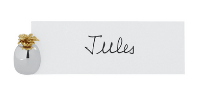 The Ercuis Pineapple Placecard Holder displays a white card with the name "Jules," its silver base and gold pineapple detail adding a charming touch to your table accessories.