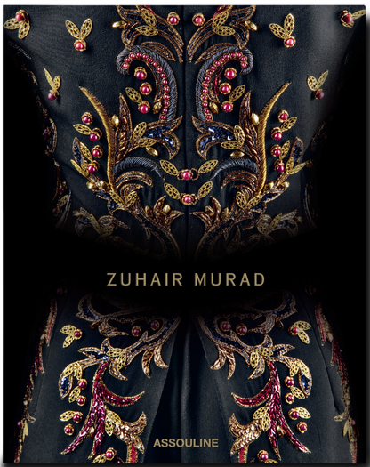 The Zuhair Murad fabric by Assouline showcases gold and red floral embroidery with exquisite handcrafted beading, featuring "ZUHAIR MURAD" at the center and "ASSOULINE" at the bottom.
