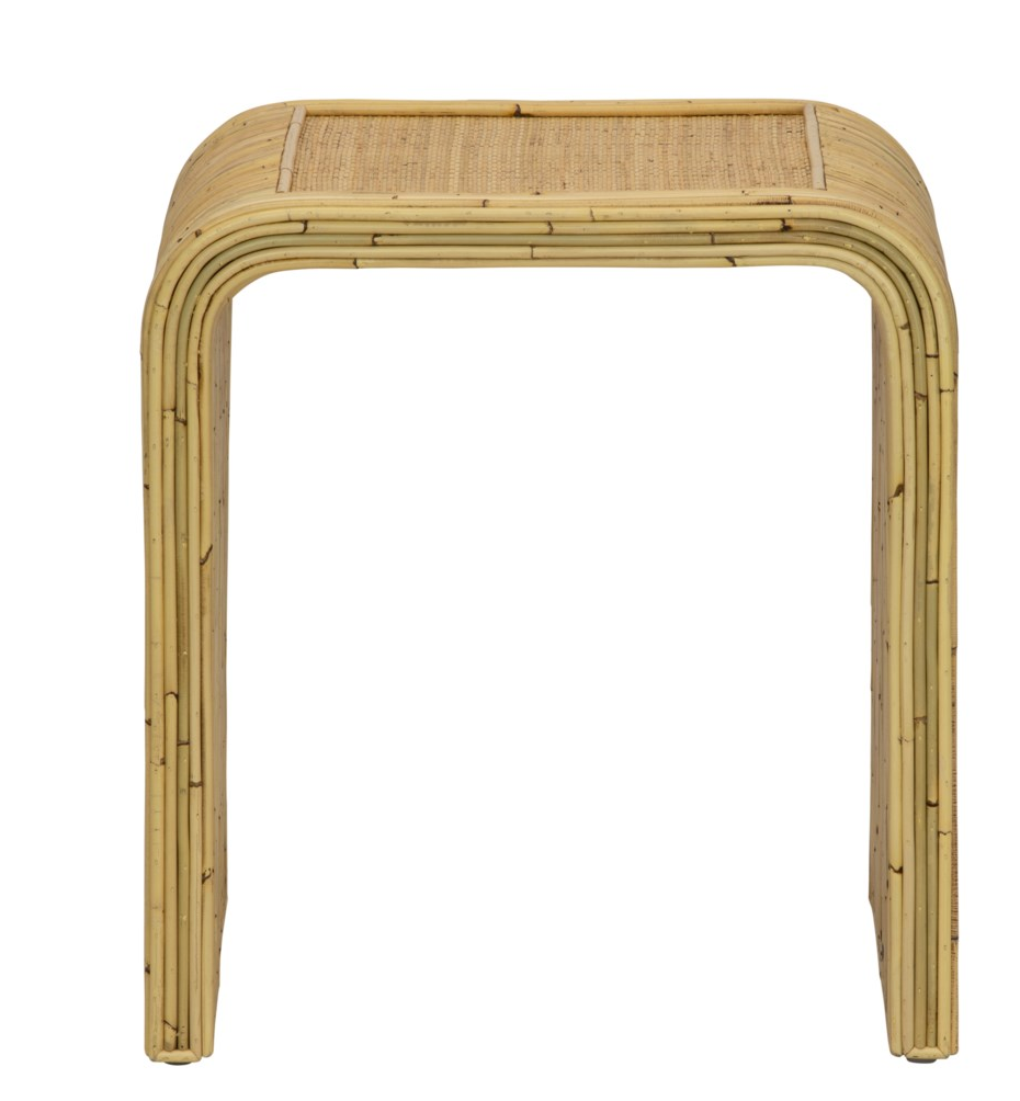 A small, rectangular rattan stool with a graceful silhouette and woven cane top, reminiscent of the natural elegance in designs like the Selamat Yosemite Falls Side Table.