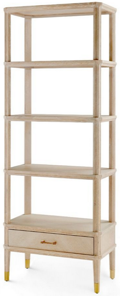 A tall, narrow wooden Bungalow5 Bertram Etagere, Cerused Oak with five open shelves and a drawer at the bottom, featuring golden feet.