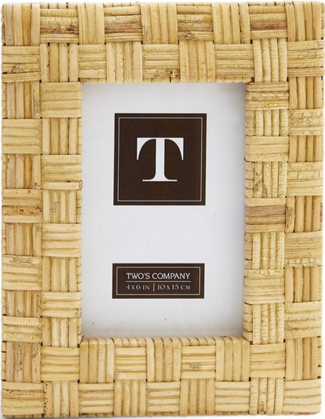 The Two's Company Natural Rattan Braided Frame, 4 x 6, features a rectangular shape and natural palette, complete with a "T" placeholder card, ideal for enhancing any home décor.