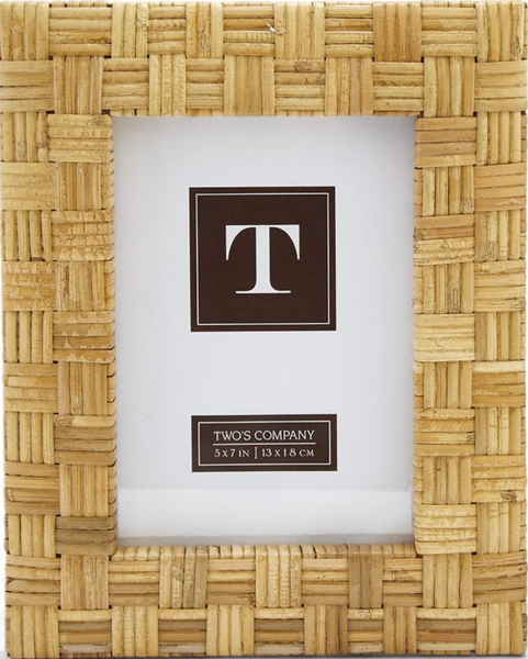 This hand-woven Natural Rattan Braided Frame by Two's Company, perfect for home décor, elegantly holds a 5x7 inches (13x18 cm) image and features a decorative "T" logo.