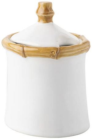The Juliska Bamboo Lidded Sugar Bowl is a white ceramic bowl with tan bamboo accents on the rim and handle—ideal for elevating your morning coffee routine.