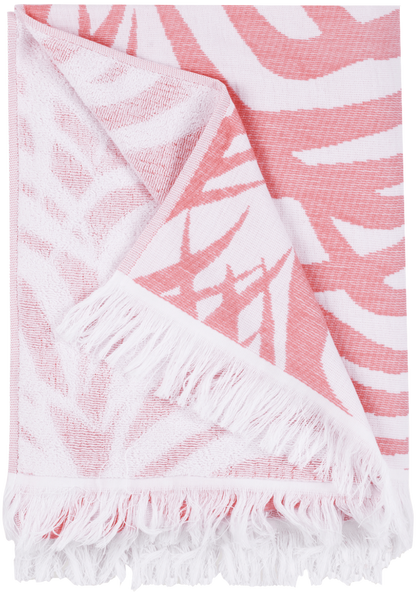 The Matouk Zebra Palm Beach Towel in Flamingo showcases a bold, abstract zebra-striped pattern in pink and white, artfully displayed to reveal both sides.