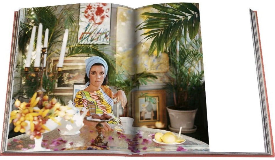 A Palm Beach picture book with a woman sitting at a table in an exclusive resort by Assouline.