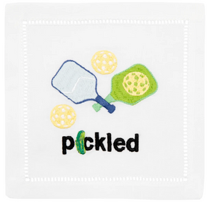 August Morgan Pickled Cocktail Napkins feature an embroidered design with two pickleball paddles, three yellow pickleballs, and the word "pickled" on elegant cotton.