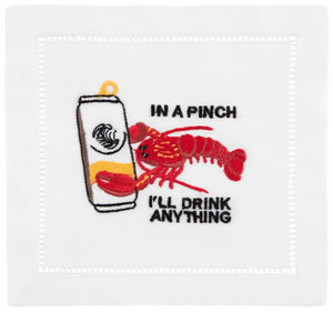 The August Morgan Lobster Cocktail Napkins feature classic hemstitching, an embroidered red lobster holding a can, and the phrase “IN A PINCH I’LL DRINK ANYTHING”—a playful touch for your next gathering.