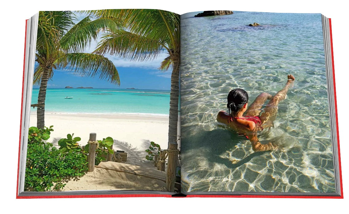 An open book on the beach in St. Barths Freedom, a paradise for luxury travelers by Assouline.