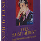 A book titled "The Impossible Collection: Yves Saint-Laurent" by Assouline with a portrait on the cover.