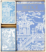 The Caspari Pagoda Toile Blue Bridge Set includes two playing card decks with blue and white Asian-inspired architectural designs and gold "BRIDGE" lettering, packaged as a boxed gift set.