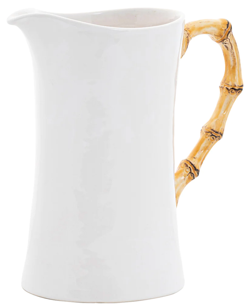 The Juliska Bamboo Large Pitcher features a white ceramic body with a curved silhouette and a bamboo-inspired handle, ideal for serving drinks or as a distinctive vase.