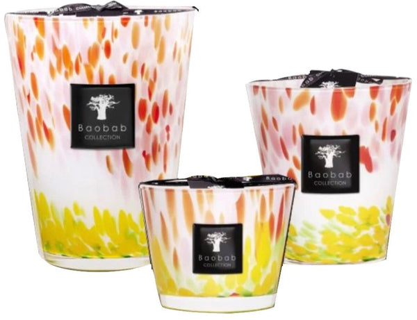 Three colorful Baobab Collection Eden Garden Candles in varying sizes with a flame-inspired design on the glass containers, inspired by the luxurious gardens of Eden.