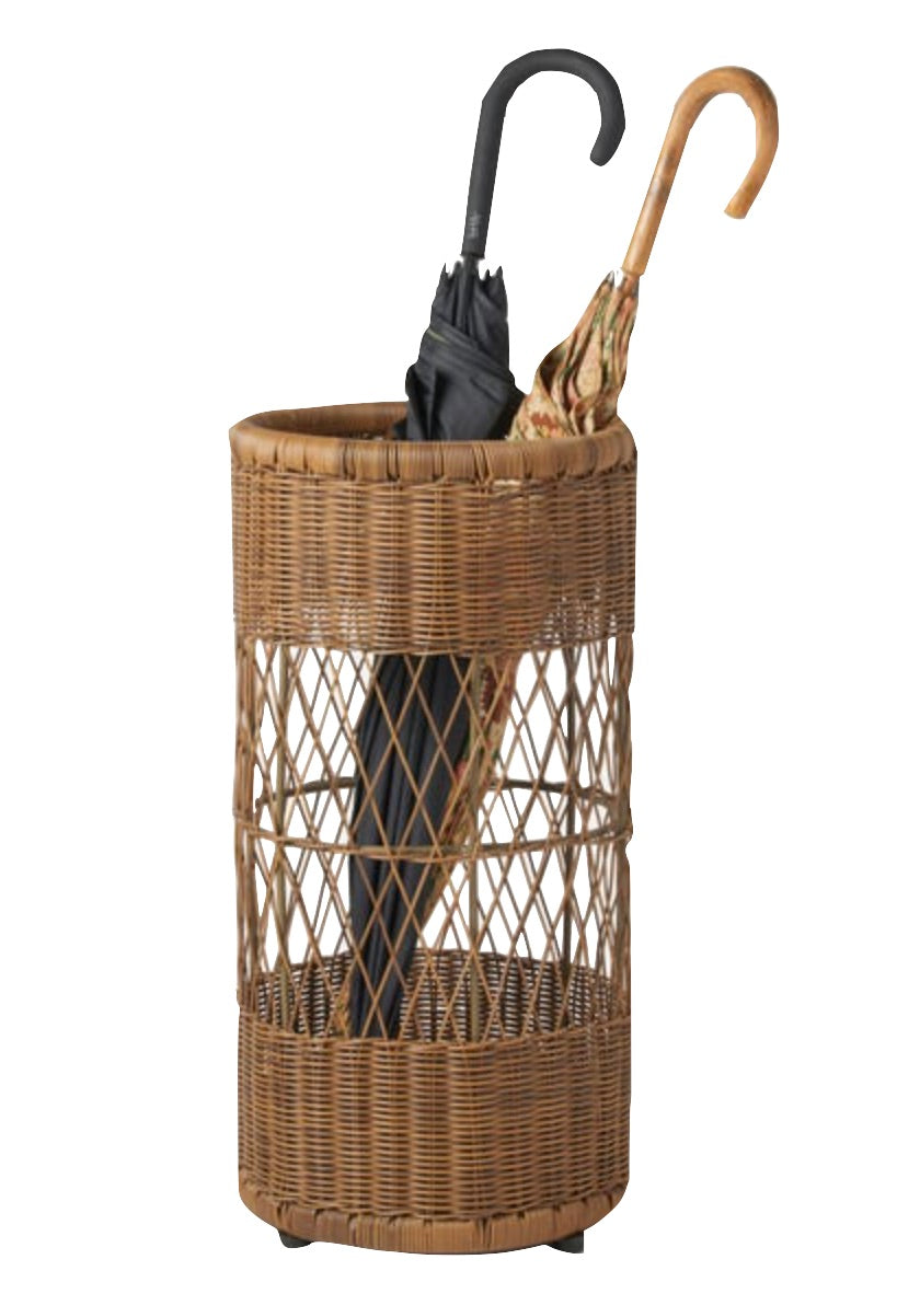 The Winburg Chestnut Rattan Umbrella Stand by Pigeon & Poodle holds a closed black umbrella and a patterned umbrella with a curved wooden handle.