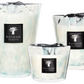 Three Baobab Pearls Sapphire candles of varying sizes with a hand-blown glass exterior in opalescent white and turquoise.