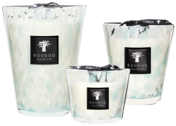 Three Baobab Pearls Sapphire candles of varying sizes with a hand-blown glass exterior in opalescent white and turquoise.