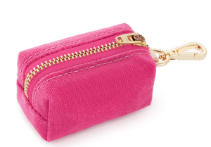 The Foggy Dog Dog Waste Bag Dispenser is a compact pink fabric pouch with a gold zipper, matching clasp, and leash clip—ideal for carrying eco-friendly poop bags in style.