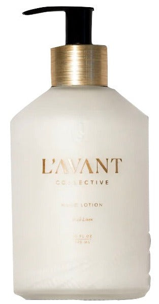 A white pump bottle labeled "L'Avant Collective Hand Lotion, Fresh Linen" with gold accents, featuring plant-based ingredients for nourishing care and a refreshing fragrance.
