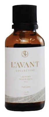 A brown bottle labeled "L'Avant Laundry Oil, Fresh Linen" by L'Avant Collective, featuring a black cap, offers a natural fresh linen scent ideal for use with wool dryer balls.