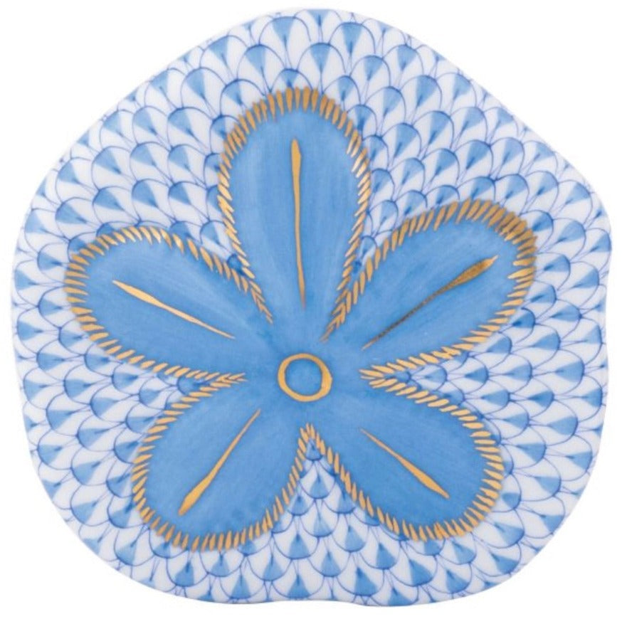 Herend's Puffy Sand Dollar plate features hand-painted blue five-petal flowers with gold accents on a white background and blue scallop pattern, showcasing artistry reminiscent of fine Herend porcelain.
