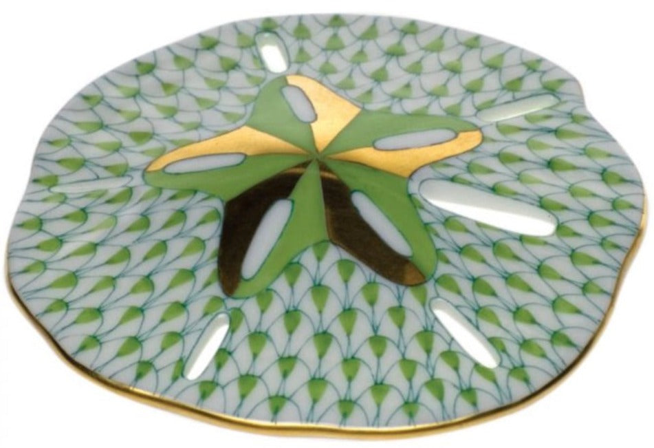 The Herend Sand Dollar porcelain plate features a hand-painted green and gold sand dollar motif with a patterned background and gold-rimmed edge—ideal for artistic display or collectors of fine porcelain.