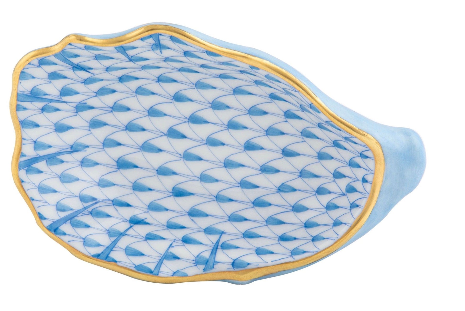 The Herend Oyster Shell is a blue and white porcelain dish shaped like a shell, hand-painted with a scalloped blue scale pattern, gold rim, and refined artistic detail.