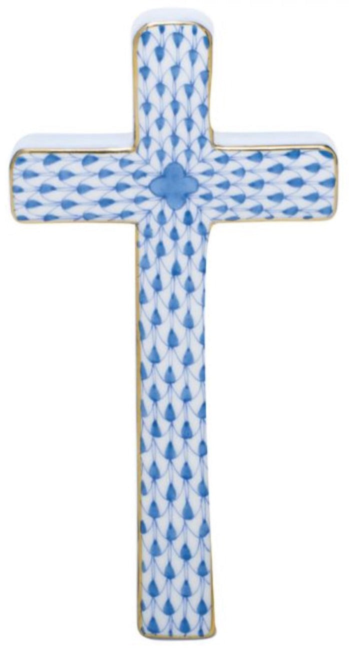 The Herend Cross is crafted from porcelain, featuring a hand-painted blue fish scale pattern with gold edges on a white background.