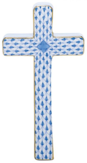 The Herend Cross is crafted from porcelain, featuring a hand-painted blue fish scale pattern with gold edges on a white background.