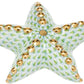 The Herend Puffy Starfish is a decorative ceramic piece featuring a green scale pattern and gold accents on each arm, inspired by classic Herend porcelain and shown on a white background.