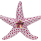 The Herend Miniature Starfish is a hand-painted porcelain figurine featuring a pink and white scale pattern and elegant gold accents at the center.