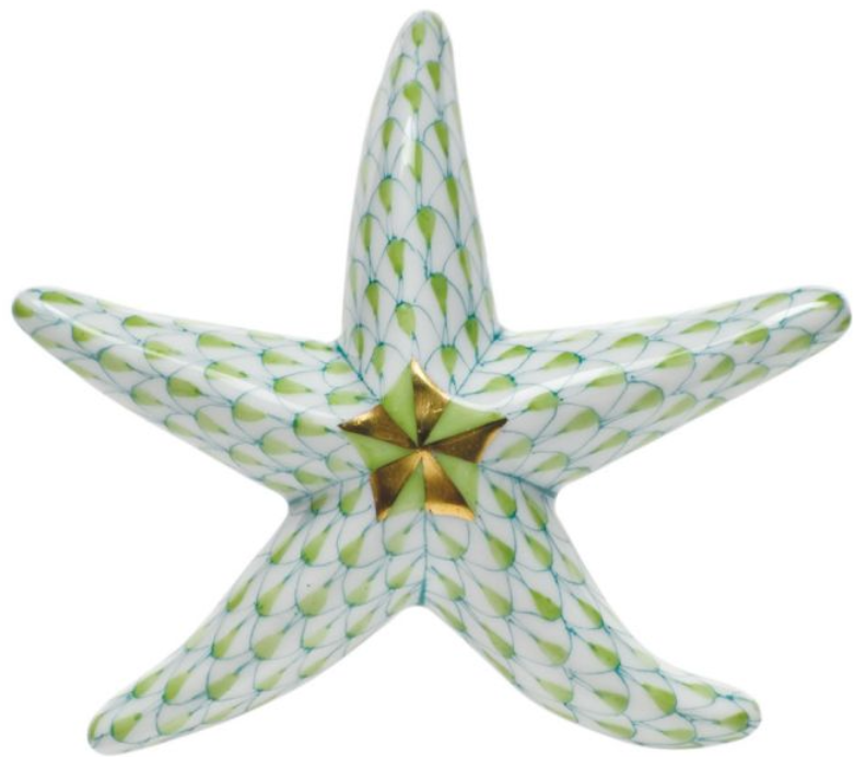 The Herend Miniature Starfish is a hand painted porcelain figurine with a green and white scale pattern and a gold center accent.