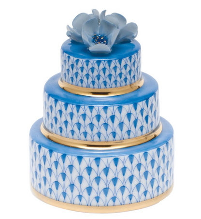 Herend Wedding Cake: a three-tiered round ceramic box featuring blue and white patterns, gold trim, and a blue flower on top, inspired by Herend porcelain with elegant hand-painted designs.