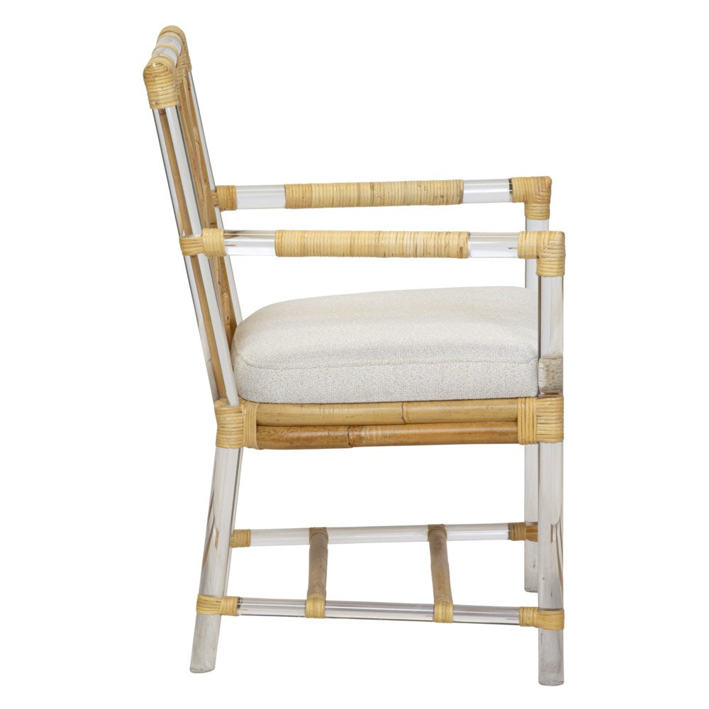 Side view of the Selamat Acrylic and Rattan Arm Chair, featuring woven rattan detailing and a padded light-colored seat. The chair, reminiscent of Sea Cliff charm, has armrests and a sturdy frame.