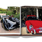 An open book displays two classic cars: a black roadster with a driver on the left page and a red vintage coupe parked under a wooden structure on the right page, reminiscent of scenes from St Tropez Soleil by Assouline.